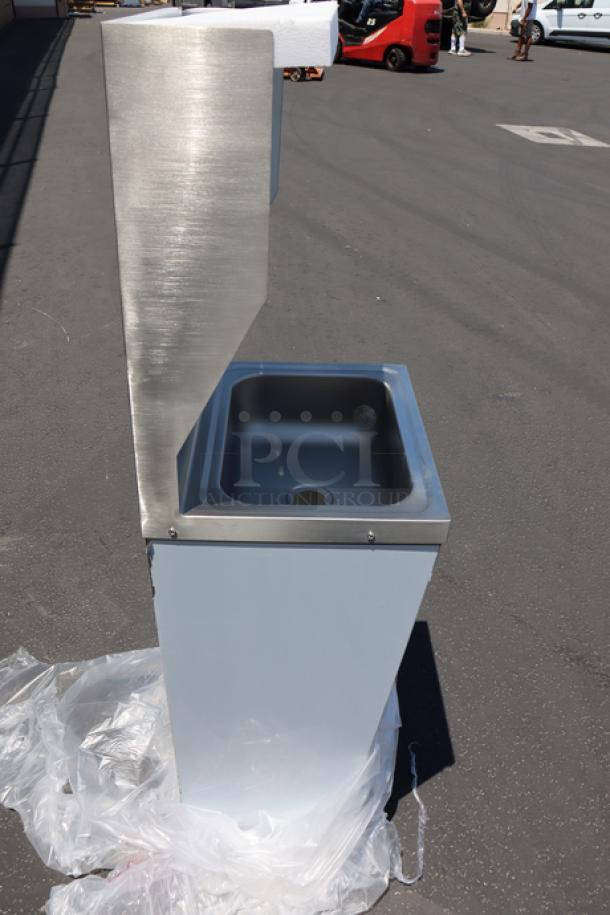 Brand new Regency 600HS17FPB hands-free hand sink with pedestal base. Top left corner is bent.