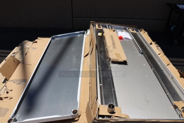 Brand new Regency 600T9B30723 stainless steel table with poly top, undershelf, and 6" backsplash. Original packaging damaged.