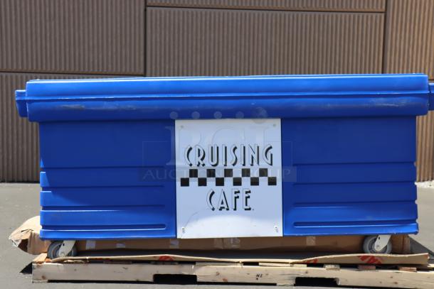 Cambro KVC854186 CamKiosk® Vending Cart in navy blue, new condition, features "Cruising Cafe" sign, four pan wells, on wheels.