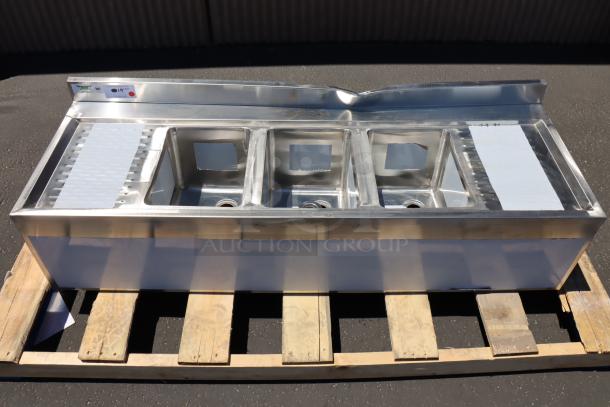 Brand new Regency 600B32160213 three-bowl underbar sink with two 13" drainboards, showing visible dent on the back splash.