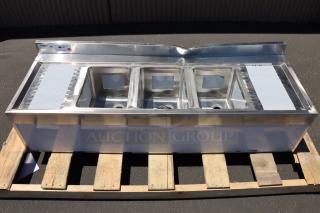 Brand new Regency 600B32160213 three-bowl underbar sink with two 13" drainboards, showing visible dent on the back splash.