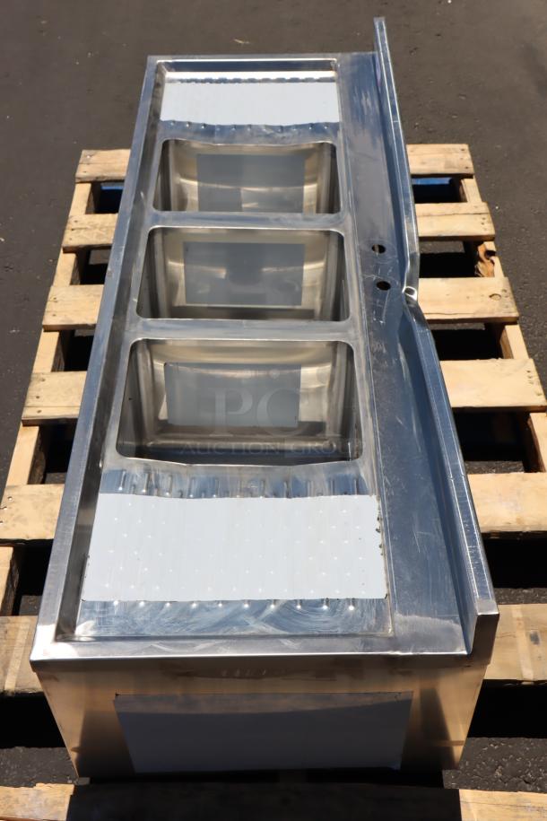Brand new Regency 60" x 21" three bowl underbar sink, model 600B32160213, with two 13" drainboards; scratch-n-dent condition.