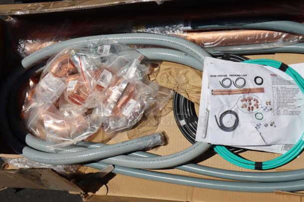 Box containing parts and accessories for Rational iCombi Pro oven, including pipes and fittings, with a visible packing list.