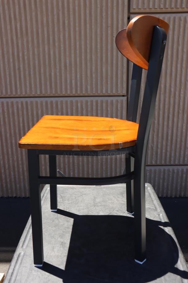 Brand new Lancaster Table & Seating boomerang style metal chair with wood seat. Out of original packaging.