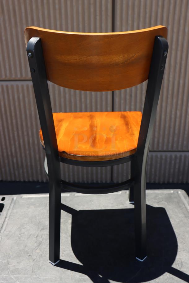 Brand new Lancaster Table & Seating boomerang style chair, metal frame, wood seat. Out of original packaging.