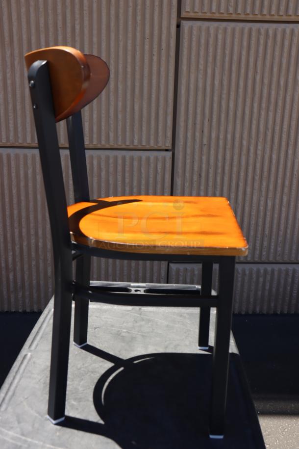 Brand new Lancaster Boomerang style metal chair, wood seat, no packaging, sleek design, excellent condition.
