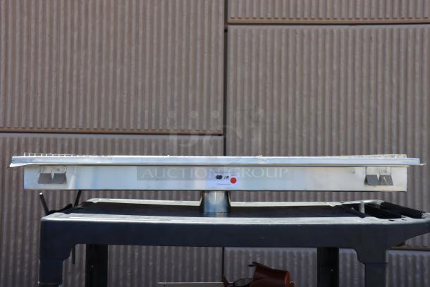 Brand new Regency 600FT1248SS 12"x48" stainless steel floor trough with grate, 14-gauge, visible minor scratches.