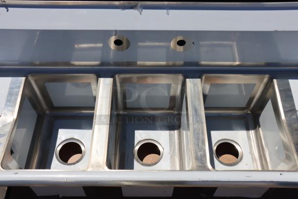 Regency 58" 16-Gauge Stainless Steel Three-Compartment Commercial Sink, model 600S31014212, with two drainboards.