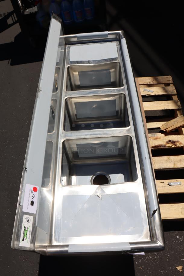 Brand new Regency 58" stainless steel three compartment sink, model 600S31014212. Features galvanized legs, 2 drainboards.