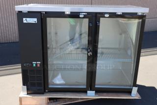 Brand new Avantco UBB-48G-HC 48" black back bar refrigerator with glass doors, LED lighting, and minor scratches.