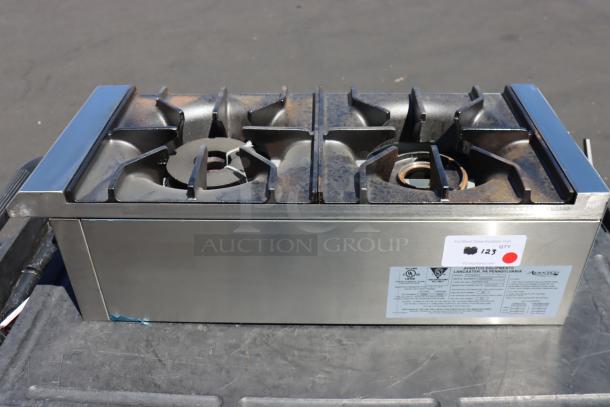 Brand new Avantco CAG-R-2-12 12" 2 burner gas range, 50,000 BTU, light scratches; serial number 1150880000006 visible.