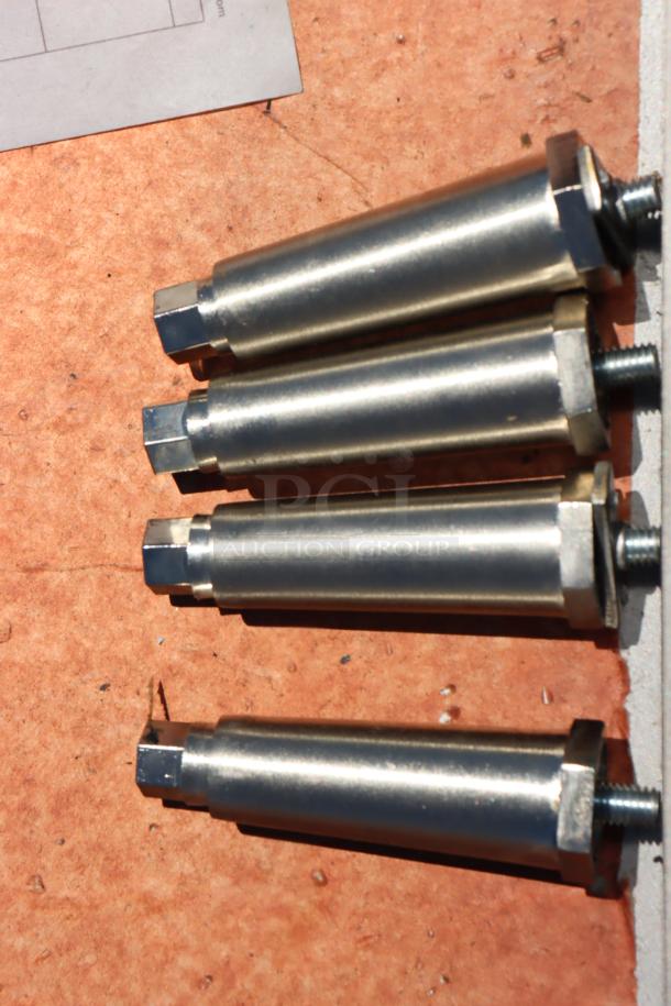Set of four stainless steel bolts for Garland ED-24G griddle, shown on orange surface.