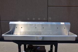 Brand new Sani-Lav 5A3F-0.5 wall-mounted hand sink, 68" x 20". Notable potential scratching and denting. Original packaging damaged.
