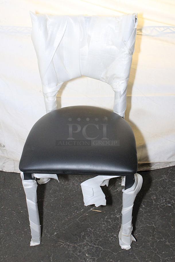 Brand new Lancaster Table & Seating chair, wrapped for protection. Black seat, sturdy frame. Part of a set of 20 chairs.