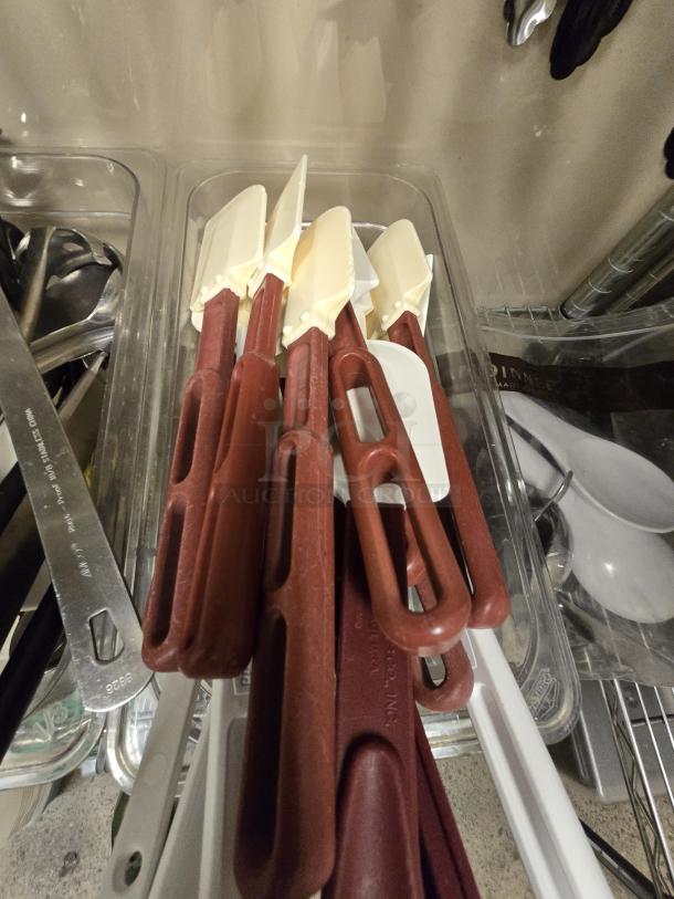ALL FOR ONE! spatulas in various sizes with red handles and cream-colored blades, in good condition.