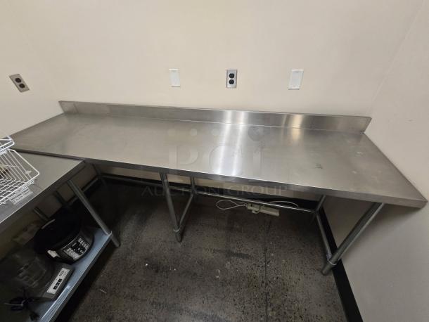 Allstrong 96"x30" stainless steel table with 5" backsplash, open base, excellent condition. Ideal for heavy-duty use.
