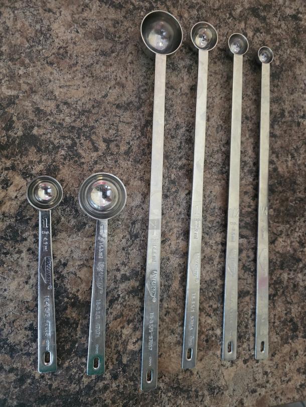 Vollrath 57057 measuring spoons, stainless steel, long-handled, red banding, marked sizes, in excellent condition.