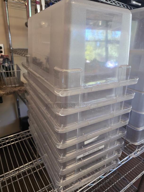 Stack of Carlisle 5 Gallon food containers on shelves, clear plastic, excellent condition. 8 containers included per bid.