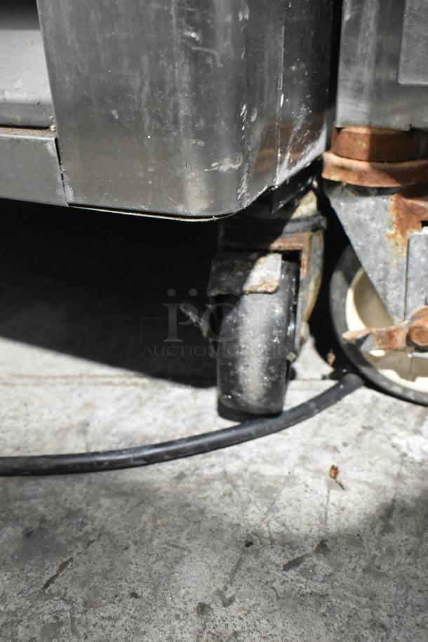 Blue Air BASR2 stainless steel commercial cooler, visible caster, 115 volts, 1 phase, showing exterior wear.