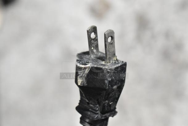 A close-up of a worn power plug for a Blue Air BASR2 cooler, showing minor wear and tear on the prongs.