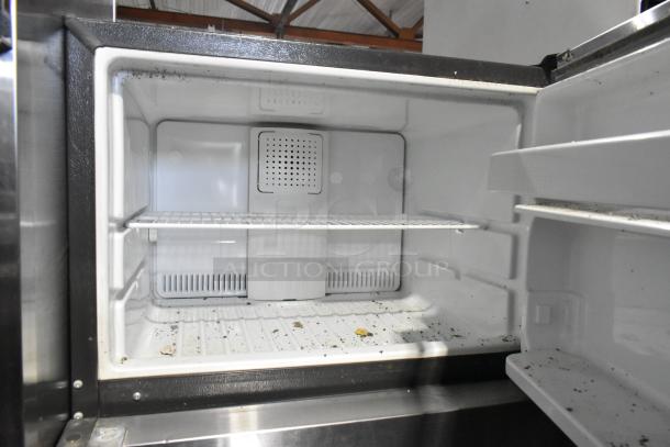 Stainless steel General Electric GTE18GSHBRSS cooler with freezer, 115V, 1 phase; used condition, visible interior wear.