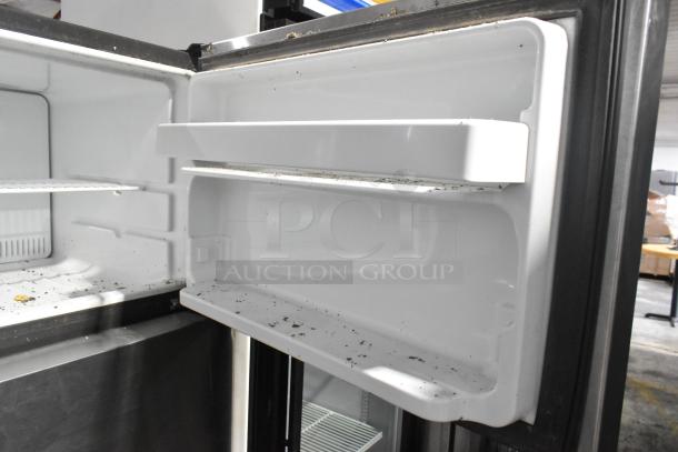 General Electric GE GTE18GSHBRSS stainless steel cooler with freezer, 115 volts, visible interior, shows signs of wear.