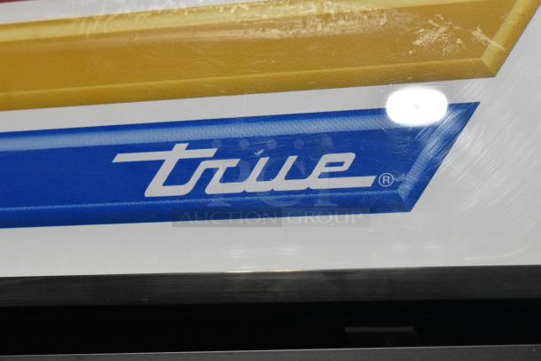 True GDM-23F commercial single door freezer, brand logo detail. Model features poly-coated racks, 115 volts, 1 phase.