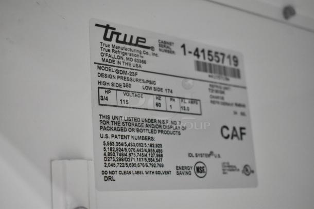 True GDM-23F metal commercial freezer with poly-coated racks, 115 volts, 1 phase. Model tag details specs and patent info.