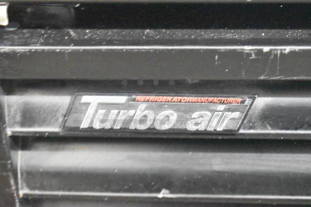 Turbo Air TGF-72FB label on commercial 3-door reach-in freezer merchandiser with poly coated racks, 115/220-240V.