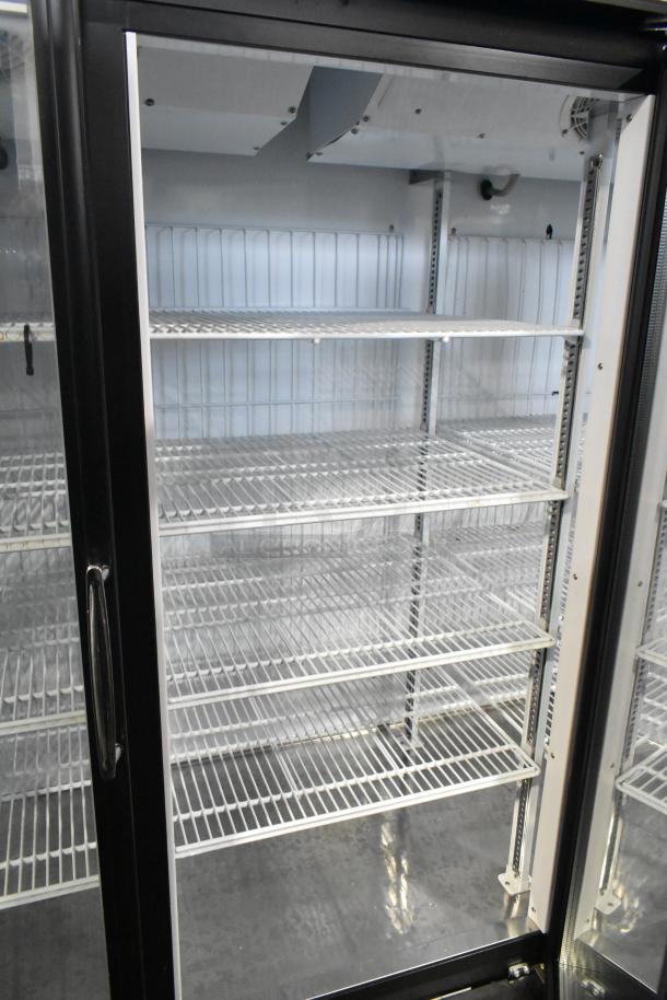 Turbo Air TGF-72FB commercial freezer with 3 glass doors, poly-coated racks, and metal frame, in clean, working condition.