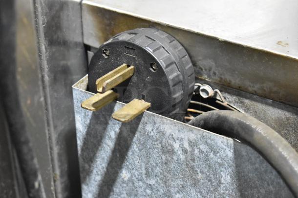 Turbochef NGC electric rapid cook oven plug detail, showing a 208/230-240 volts power cord and metal casing.