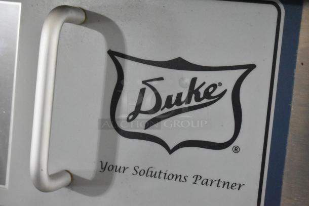 Duke TSC-6/18 stainless steel oven proofer, commercial floor style, on casters. Features handle and brand logo.