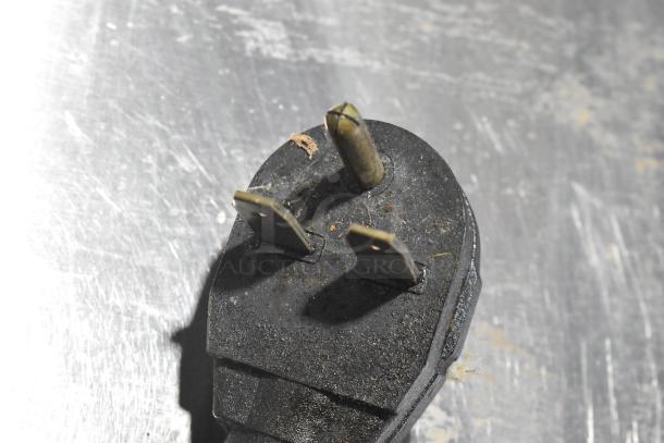 Close-up of a power plug for the Merrychef eikon e4 rapid cook oven, showing prongs and wear.