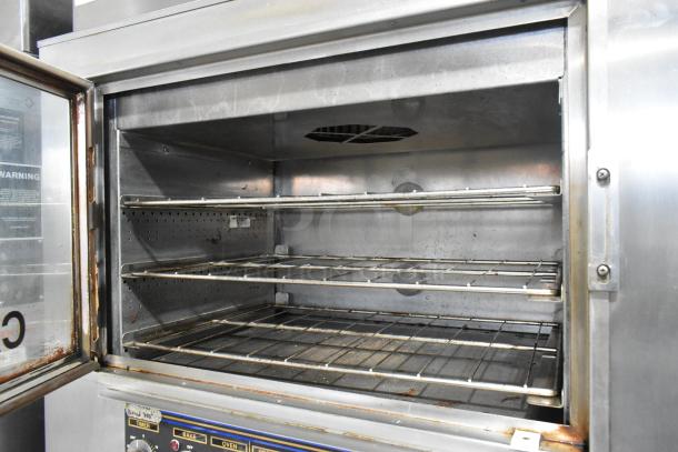 Nu Vu SUB-123 stainless steel commercial oven proofer with three wire racks, viewed open, on casters. 208V, 3 phase.