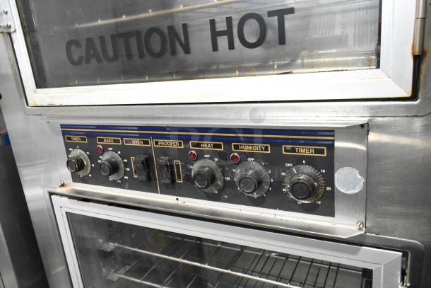 Nu Vu SUB-123 stainless steel commercial oven proofer with controls for baking, heat, humidity, and timer. "Caution Hot" label visible.