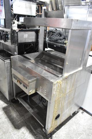 Franke stainless steel commercial dumping warming station, used condition, visible wear with some residue, robust design.