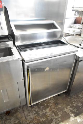 Silver King SKFSM stainless steel commercial prep table with casters, 115V, 1 phase. Features hinged top, excellent condition.