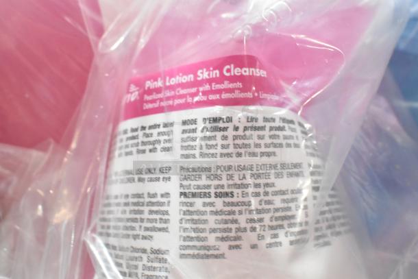 Plastic-wrapped Pink Lotion Skin Cleanser bottle with detailed product instructions and safety information visible.
