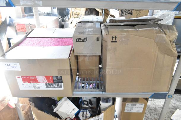 Tier lot with 3M Red Buffer Pads, Purell soap dispenser, Diversey Glance cleaner; assorted storage boxes, moderate wear.