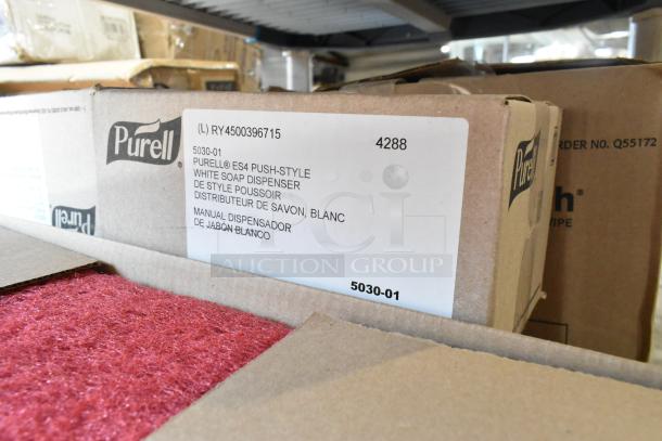Auction lot with 3M red buffer pads, Purell white soap dispenser box, and Diversey cleaner. Visible label indicates Purell model 5030-01.