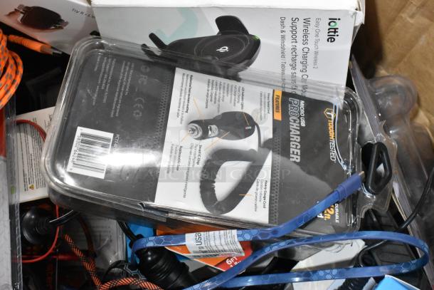 Tier lot with car chargers, Zebra label rolls, chargers, and accessories. Includes iOttie wireless charger. Mixed condition.