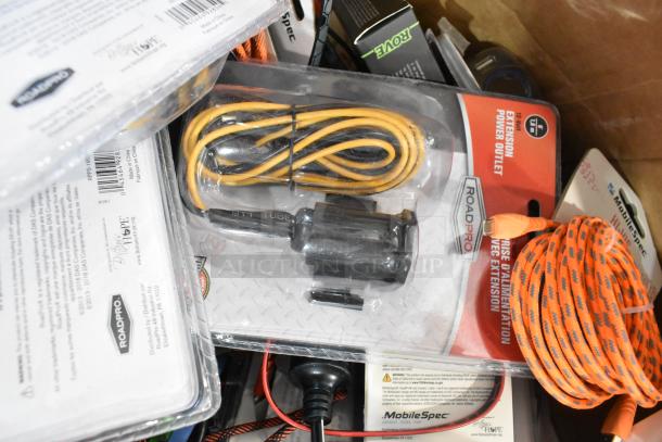 Tier lot of assorted items including RoadPro and MobileSpec car chargers, orange extension cord, and Zebra label rolls.
