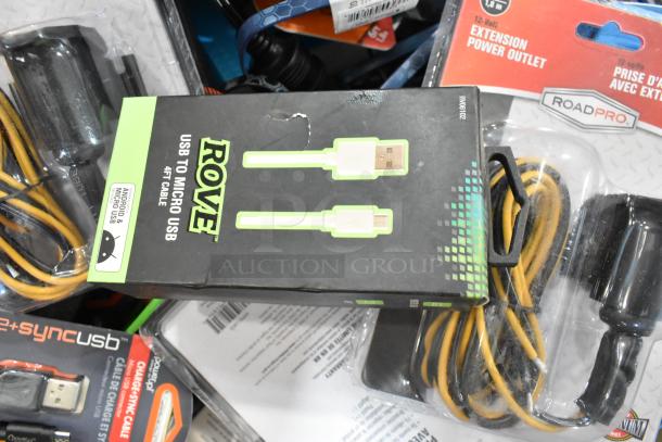 Assorted electronic items including Rove USB to Micro USB cable, RoadPro 12V extension power outlet, and car chargers.