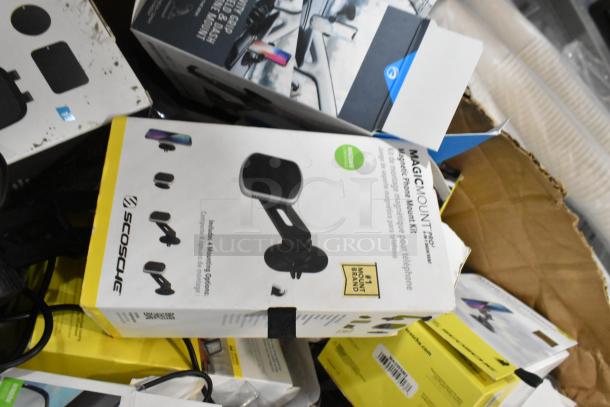Lot of various items, including Scosche phone mounts in original packaging, showing signs of wear.