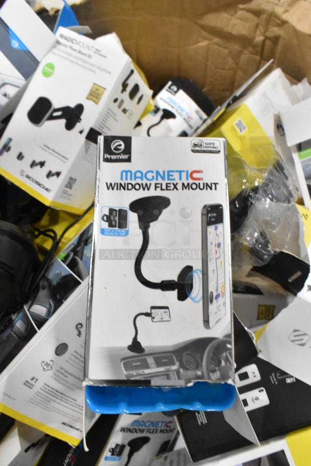 Lot of phone mounts including Premier Magnetic Window Flex Mount, new in box with various packaging visible in the background.