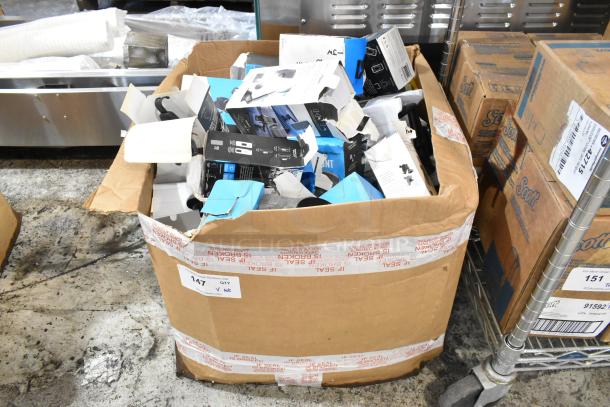 Box of assorted items including phone mounts, slightly damaged packaging, labeled for auction, lot number 147.
