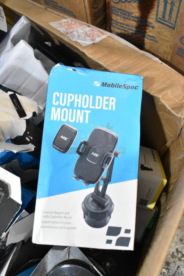 MobileSpec Cupholder Mount in original packaging, visible wear on box. Universal magnet and cradle design for phones.