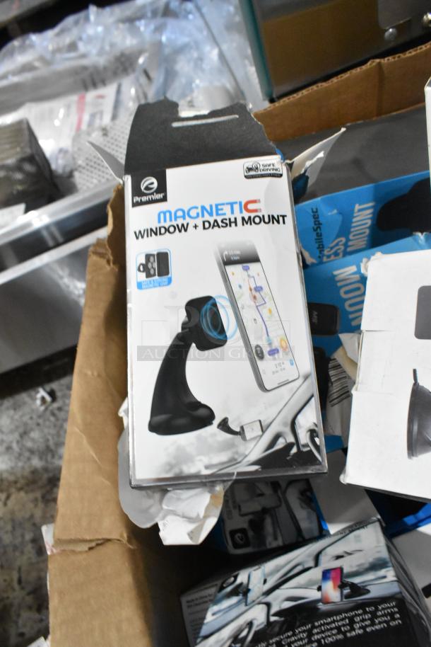 Lot of phone mounts including Premier Magnetic Window and Dash Mount, in original packaging, visible wear on boxes.
