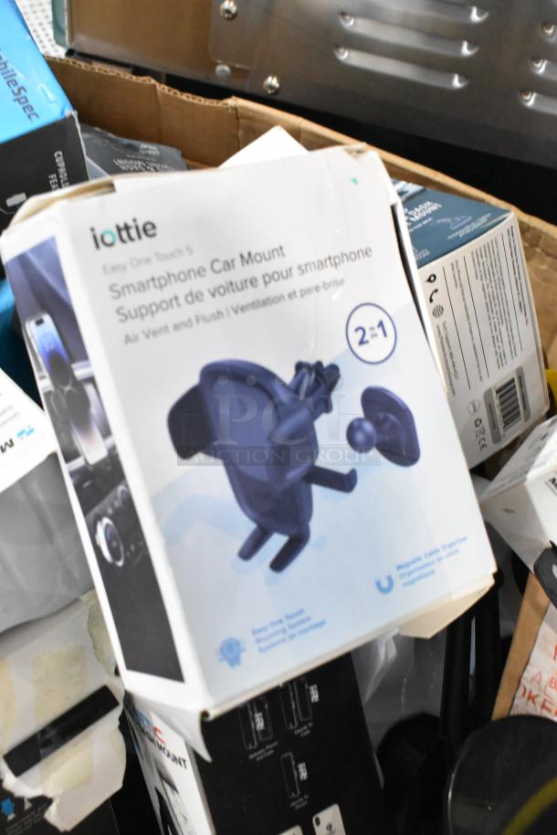 Lot of various items including iOttie Easy One Touch 5 smartphone car mount in original packaging, visible wear on box.