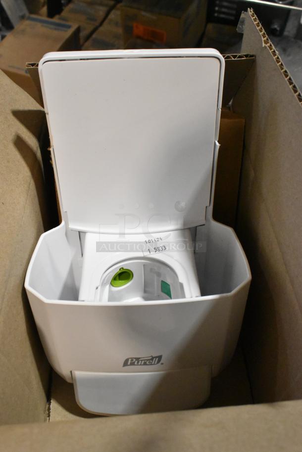Purell white soap dispenser in open cardboard box, showing interior. New condition. Label with numbers 101424 and 58333.